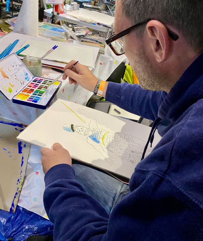 Jason painting at his desk